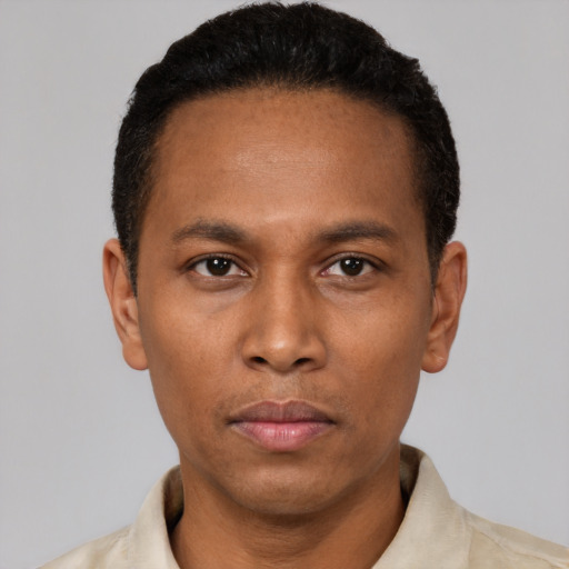 Neutral black adult male with short  black hair and brown eyes
