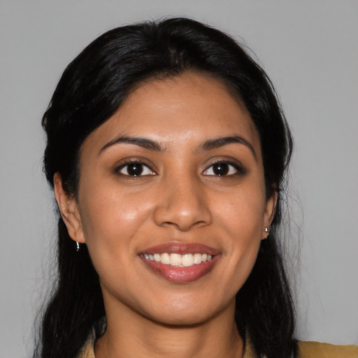 Joyful latino young-adult female with long  black hair and brown eyes