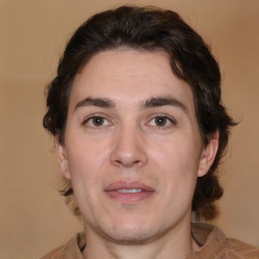 Joyful white adult male with medium  brown hair and brown eyes