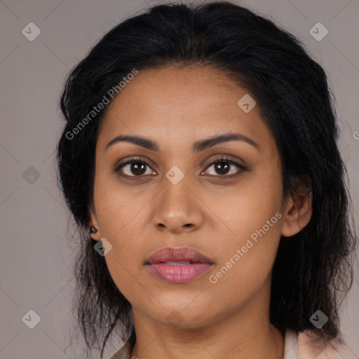 Joyful latino young-adult female with long  brown hair and brown eyes