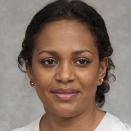 Joyful black adult female with short  brown hair and brown eyes