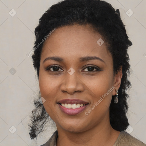 Joyful black young-adult female with long  black hair and brown eyes