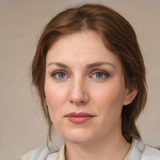 Joyful white young-adult female with medium  brown hair and green eyes