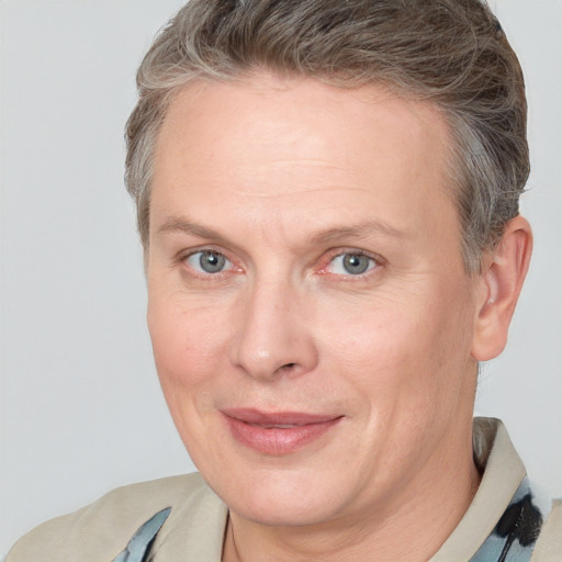 Joyful white adult female with short  brown hair and grey eyes