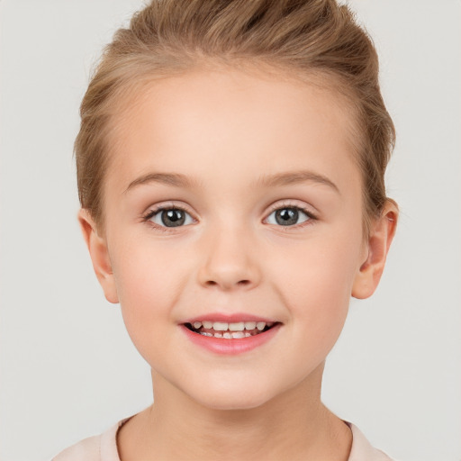 Joyful white child female with short  brown hair and brown eyes