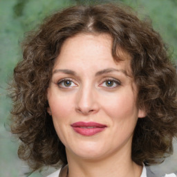 Joyful white young-adult female with medium  brown hair and green eyes