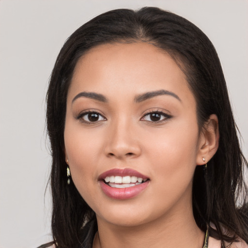 Joyful white young-adult female with long  black hair and brown eyes