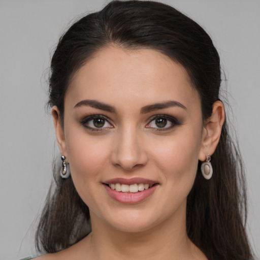 Joyful white young-adult female with long  brown hair and brown eyes