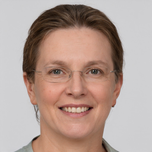 Joyful white adult female with short  brown hair and grey eyes