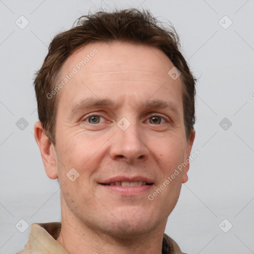 Joyful white adult male with short  brown hair and grey eyes