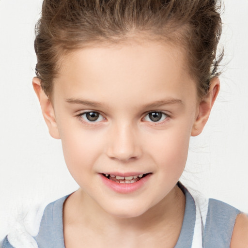 Joyful white child female with short  brown hair and brown eyes