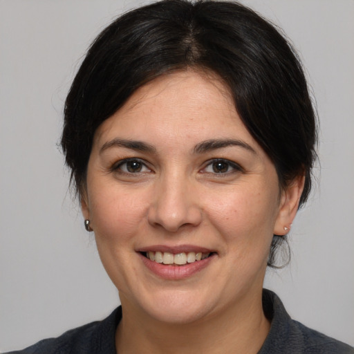 Joyful white adult female with medium  brown hair and brown eyes