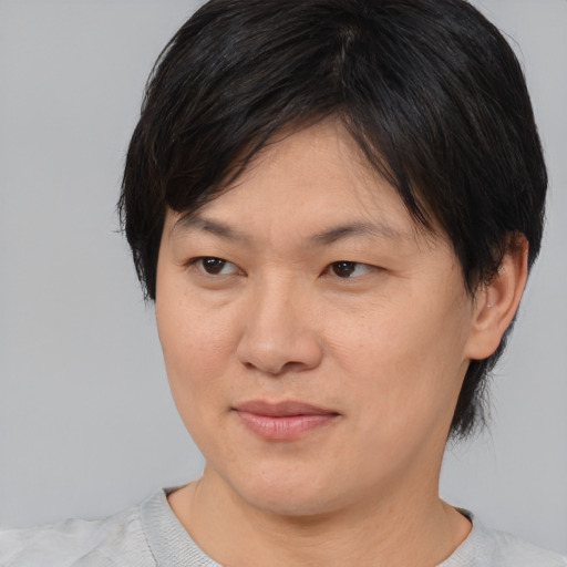Joyful asian adult female with short  brown hair and brown eyes