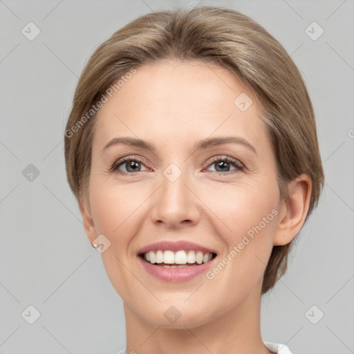 Joyful white young-adult female with medium  brown hair and grey eyes