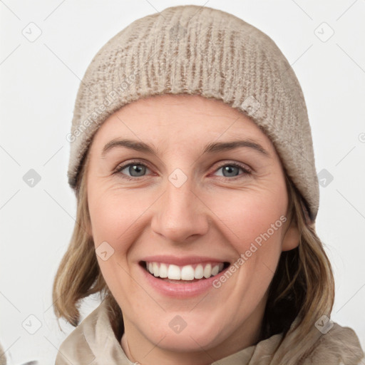 Joyful white young-adult female with medium  brown hair and blue eyes