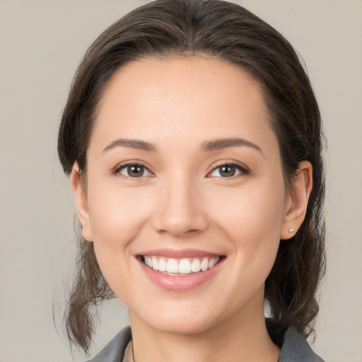 Joyful white young-adult female with medium  brown hair and brown eyes