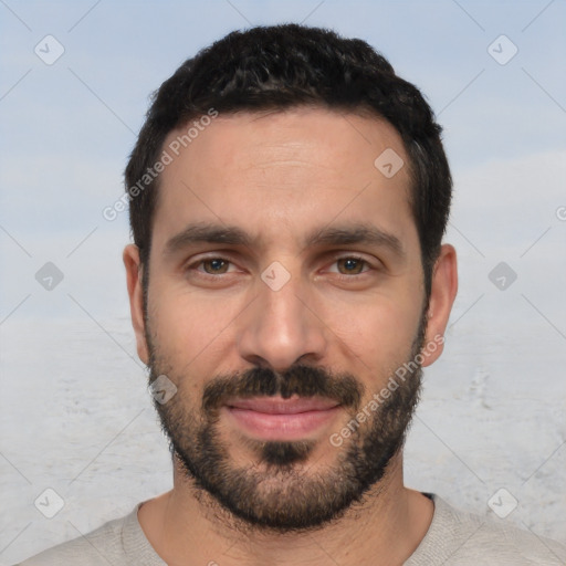 Joyful white young-adult male with short  black hair and brown eyes