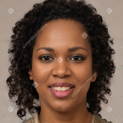 Joyful black young-adult female with long  brown hair and brown eyes