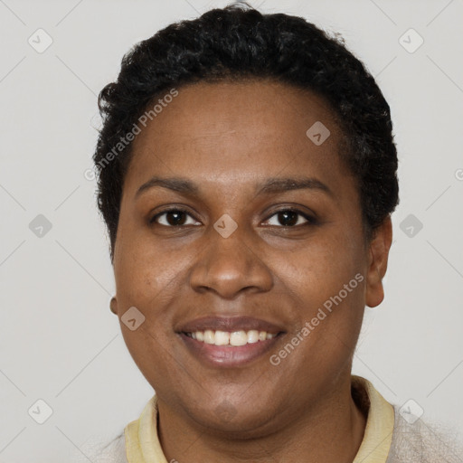 Joyful black young-adult female with short  brown hair and brown eyes