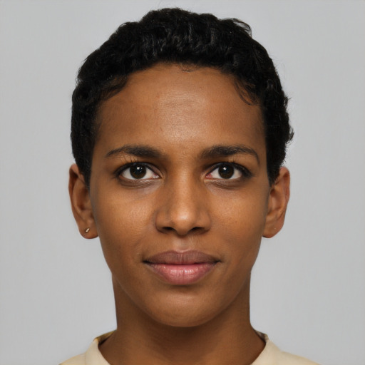 Joyful black young-adult female with short  black hair and brown eyes