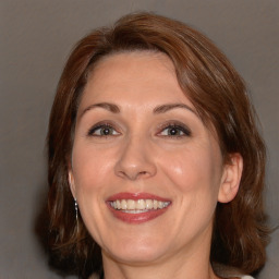 Joyful white adult female with medium  brown hair and brown eyes