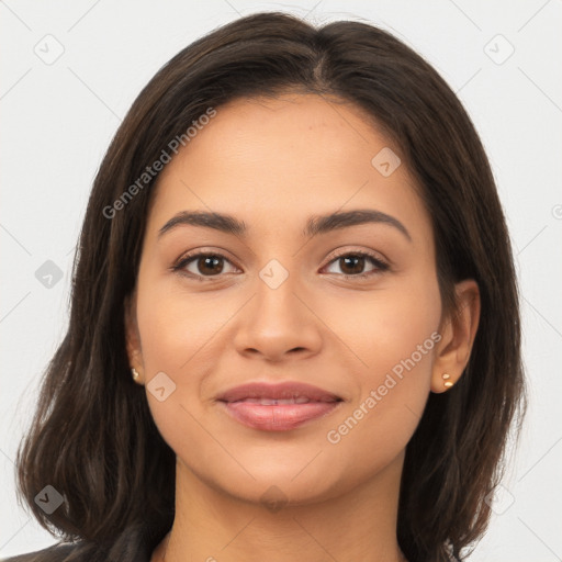 Joyful latino young-adult female with long  brown hair and brown eyes