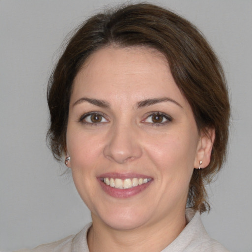 Joyful white young-adult female with medium  brown hair and brown eyes