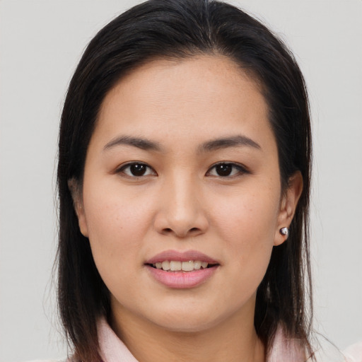 Joyful asian young-adult female with medium  brown hair and brown eyes