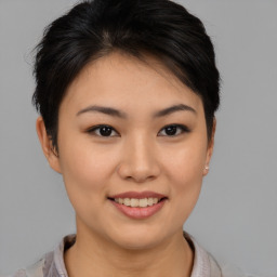 Joyful asian young-adult female with short  brown hair and brown eyes