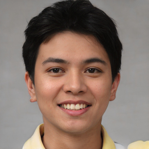 Joyful asian young-adult male with short  brown hair and brown eyes