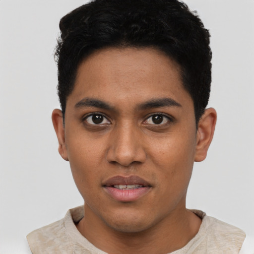 Joyful latino young-adult male with short  black hair and brown eyes