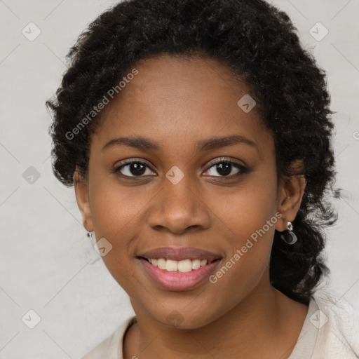 Joyful black young-adult female with long  brown hair and brown eyes