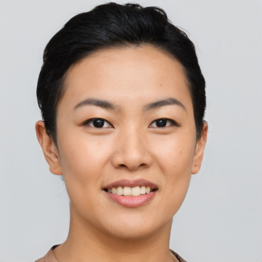 Joyful asian young-adult female with short  black hair and brown eyes