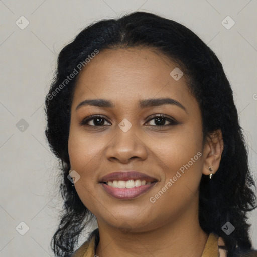 Joyful black young-adult female with long  black hair and brown eyes