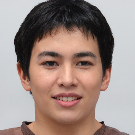Joyful asian young-adult male with short  brown hair and brown eyes