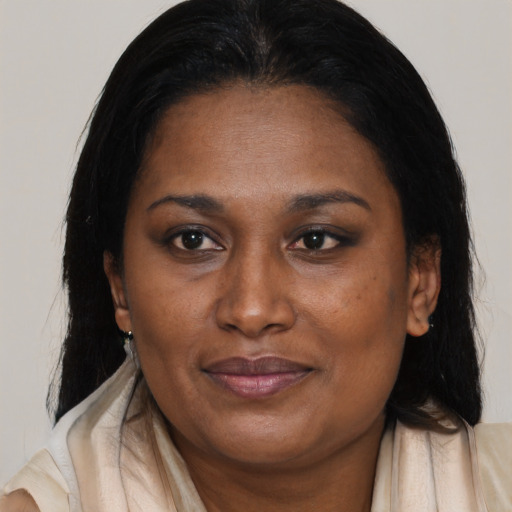Joyful black adult female with medium  brown hair and brown eyes
