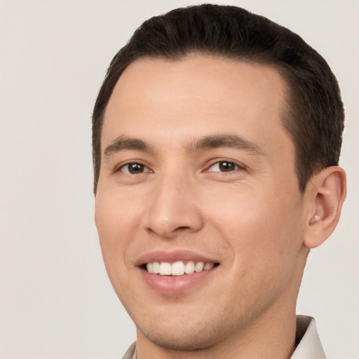 Joyful white young-adult male with short  brown hair and brown eyes