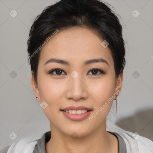 Joyful asian young-adult female with short  black hair and brown eyes