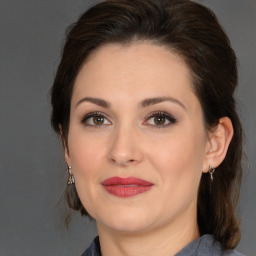 Joyful white young-adult female with medium  brown hair and brown eyes