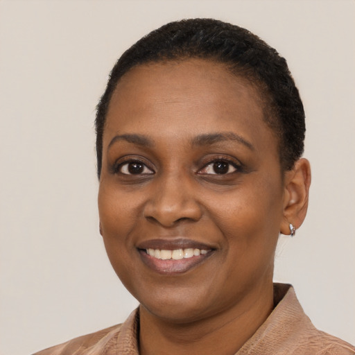 Joyful black young-adult female with short  black hair and brown eyes
