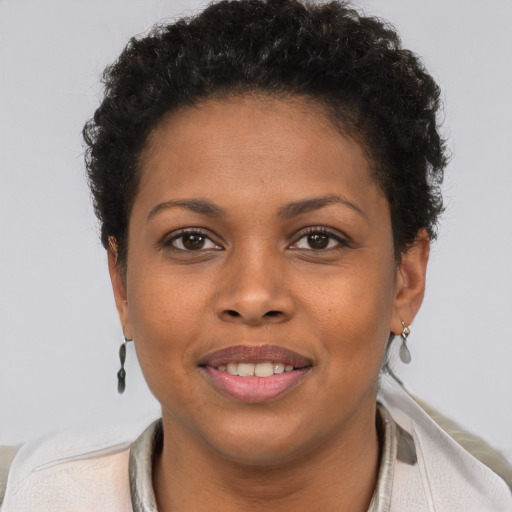 Joyful black young-adult female with short  brown hair and brown eyes