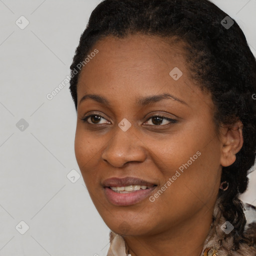 Joyful black young-adult female with short  black hair and brown eyes