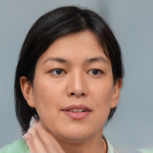 Neutral asian young-adult female with medium  brown hair and brown eyes
