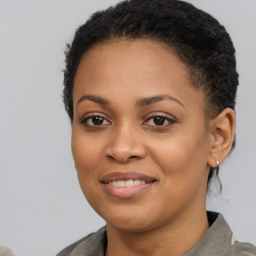 Joyful black young-adult female with short  brown hair and brown eyes