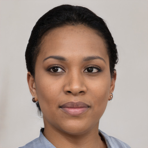 Joyful black young-adult female with short  black hair and brown eyes