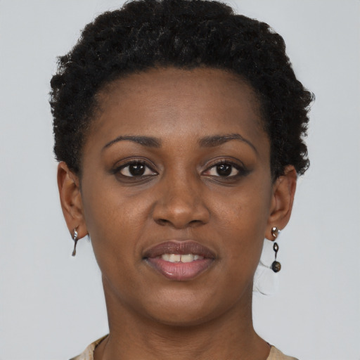 Joyful black young-adult female with short  brown hair and brown eyes