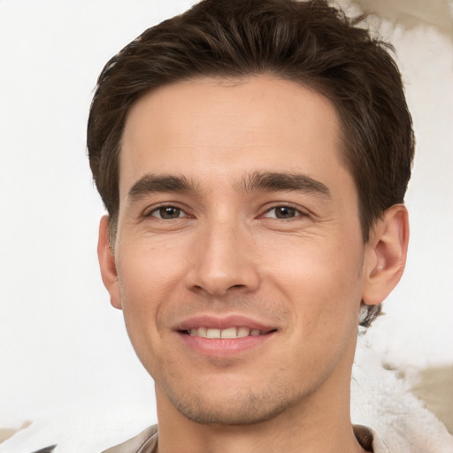 Joyful white young-adult male with short  brown hair and brown eyes