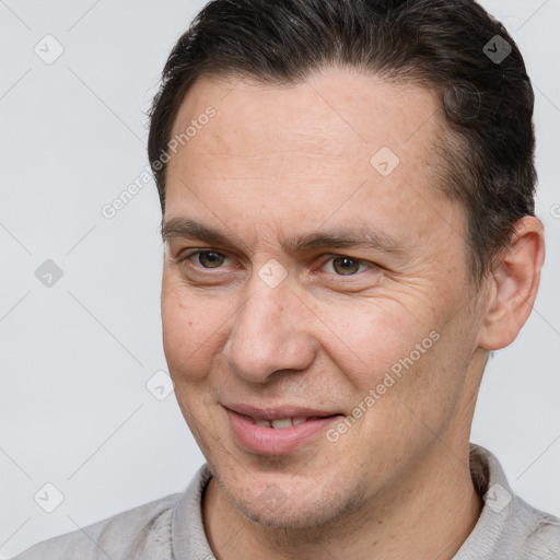 Joyful white adult male with short  brown hair and brown eyes