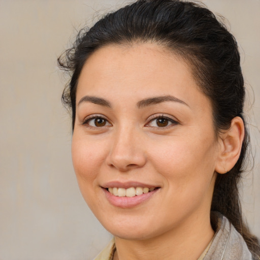 Joyful white young-adult female with long  brown hair and brown eyes