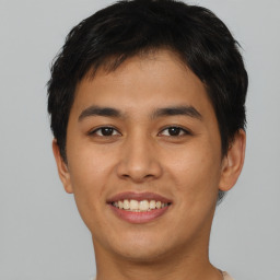 Joyful asian young-adult male with short  brown hair and brown eyes